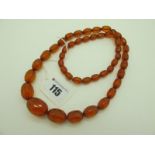A Long Graduated Amber Coloured Faceted Bead Necklace.
