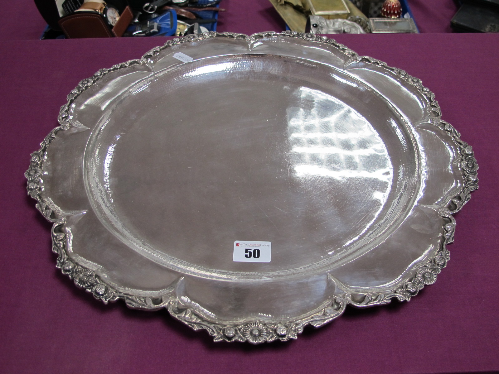 A Decorative Circular Platter/Charger, of shaped design within textured foliate border, indistinctly