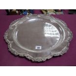 A Decorative Circular Platter/Charger, of shaped design within textured foliate border, indistinctly