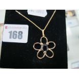 A Modern Openwork Flower Pendant, with oval claw set centre, stamped "750", on fine chain,