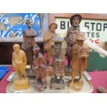 Seven Carved Wooden Figures, including Chinese Gentleman holding fish, 20 cm high:- One Tray