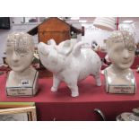 Two Pottery Phrenology Heads, after L.N. Fowler, 23 cm high. Pottery winged pig. (3)