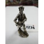 A Silver Figure of a Gentleman with Hat & Scarf in Hand, London Hallmark to base, 5 cm high.