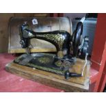 The Singer Manufacturing Co Hand Sewing Machine, gilt decorated, in domed case.