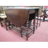 A 1920's Oak Oval Topped Gate leg Table, having barley twist supports, 91cm wide.