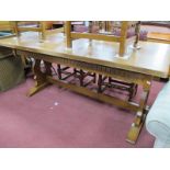 An Oak Refectory Dining Table, with knurled carving, trestle ends, 193 cm wide.