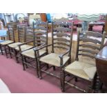 A Set of Six (four single and two carver) Country Style Dining Chairs, each with wavy ladder back
