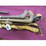 Seven Walking Sticks, one with a twisted stem, all rustic looking.