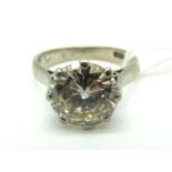 A Large Single Stone Diamond Ring, the (10mm) brilliant cut stone eight claw set, between plain