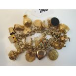 A Chunky 9ct Gold Curb Link Charm Bracelet, to decorative heart shape padlock clasp, suspending