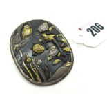 A XIX Century Japanese Shakudo Panel Brooch, of oval form depicting birds and foliage, 5.5 cm long.