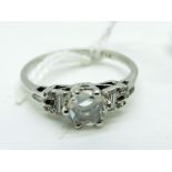 A Single Stone Diamond Ring, the central stone claw set between inset shoulders stamped "PLAT" (