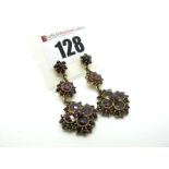 A Pair of Garnet Set Drop Earrings, of graduated triple cluster design claw and collet set (later