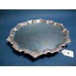 A Mappin & Webb Plated Salver, of antique style within decorative shaped border, raised on three