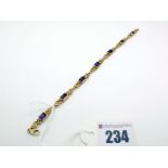 A 9ct Gold Amethyst Set Bracelet, of fancy link design, rectangular collet set, 19.5cm long.