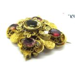 A Large Victorian Locket Back Brooch, of shaped design with filigree detail and oval collet set