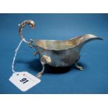 A Hallmarked Silver Sauce Boat, SB & S, Birmingham (date letter rubbed), with wavy cut edge and leaf