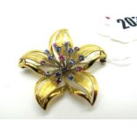 A Modern Flowerhead Brooch, of openwork design of textured and polished finish, claw set to the