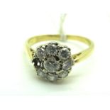 A Diamond Cluster Ring, claw set throughout with graduated brilliant cut stones (one missing),