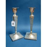 A Pair of Hallmarked Silver Candlesticks, Walker & Hall, Sheffield 1938, each of plain geometric