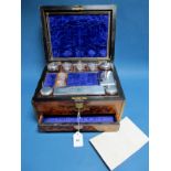 A XIX Century Walnut Travelling Box, the plush lined fitted interior with assorted stoppered glass