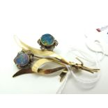 An Opal Doublet Set Floral Spray Brooch, oval collet set centre to flowers, of openwork design,