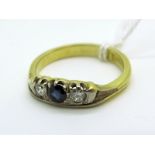 An 18ct Gold Three Stone Ring, alternately set, with two brilliant cut diamonds, within flat sided