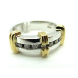 A Modern 9ct Gold Two Tone Diamond Dress Ring, the brilliant cut stones channel set, between plain