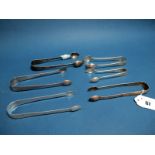 Three Pairs of Hallmarked Silver Sugar Tongs, (various makers and dates) each with bright cut