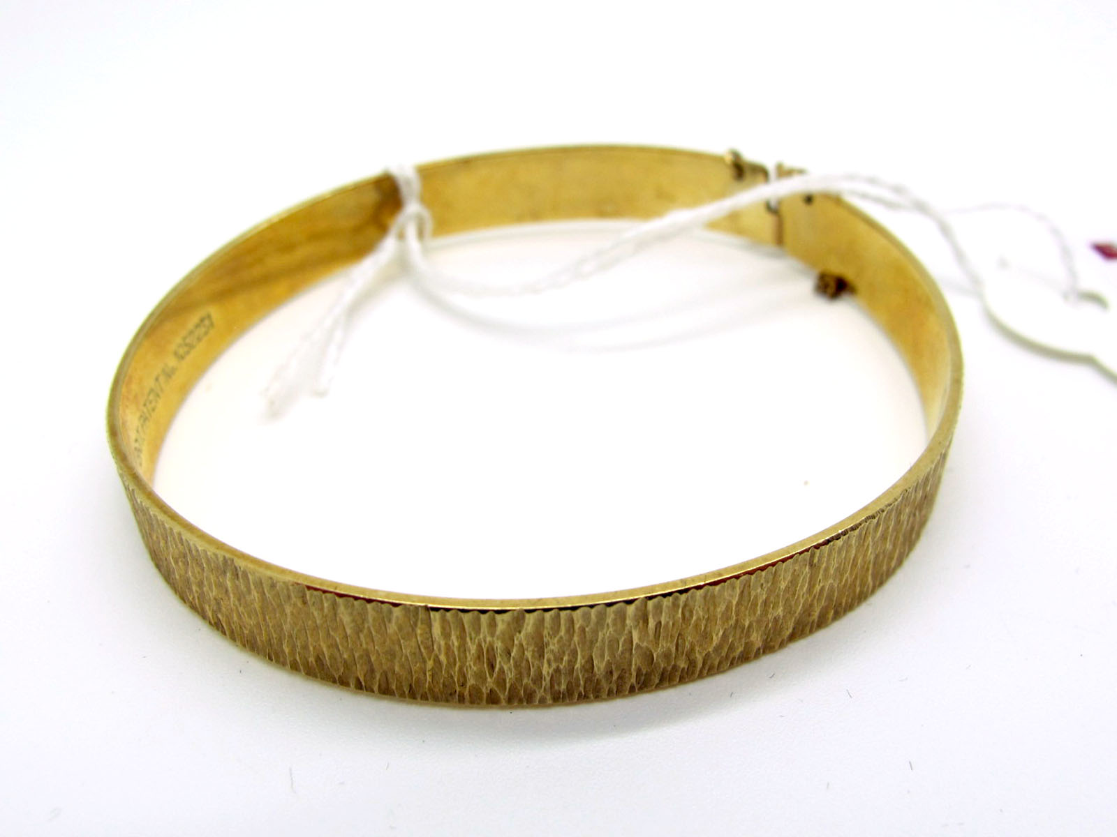A 9ct Gold Bangle, of textured bark design (15grams).