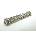 A Stylish Art Deco Diamond Set Bar Brooch, of geometric pierced design, set throughout with