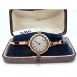 A 9ct Gold Cased Ladies Wristwatch, the mother of pearl dial (cracked) with black Arabic numerals,