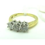 A Modern 18ct Gold Three Stone Diamond Ring, the uniform brilliant cut stones claw set, stamped "Dia
