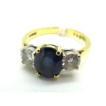 An 18ct Gold Sapphire and Diamond Three Stone Ring, the central oval sapphire four claw set