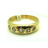 An 18ct Gold Diamond Set Ring, alternately star set with diamond chips, Birmingham 1896, (finger