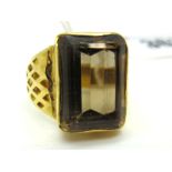 A Middle Eastern Style Single Stone Dress Ring, rectangular collet rubover set, between tapering