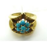 A Large Cluster Style Dress Ring, with a claw set turquoise coloured flowerhead centre, within an