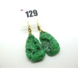 A Pair of Carved Green Hardstone Earrings, each of abstract design, suspended from hook fittings.