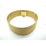 A Wide Bracelet of Uniform Textured Design, to snap clasp, stamped "750" (51grams).