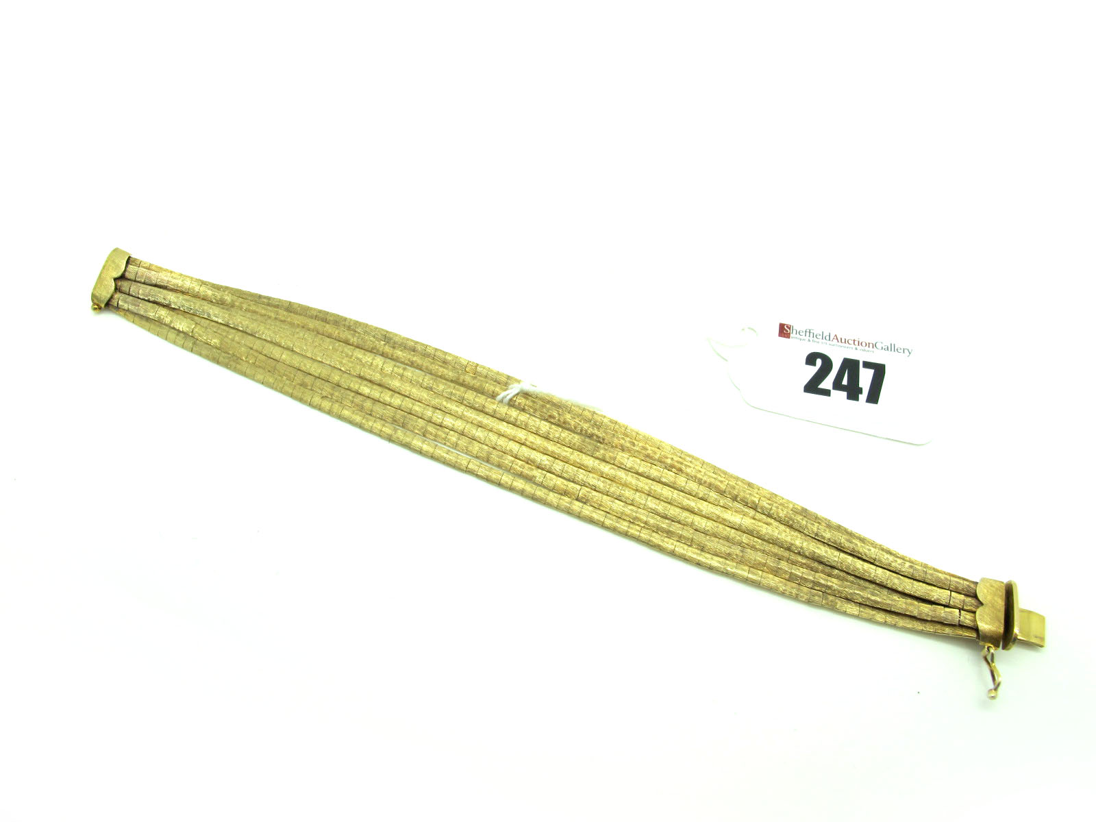 A 9ct Gold Seven Row Bracelet, of uniform design, to snap clasp, 19cm long.