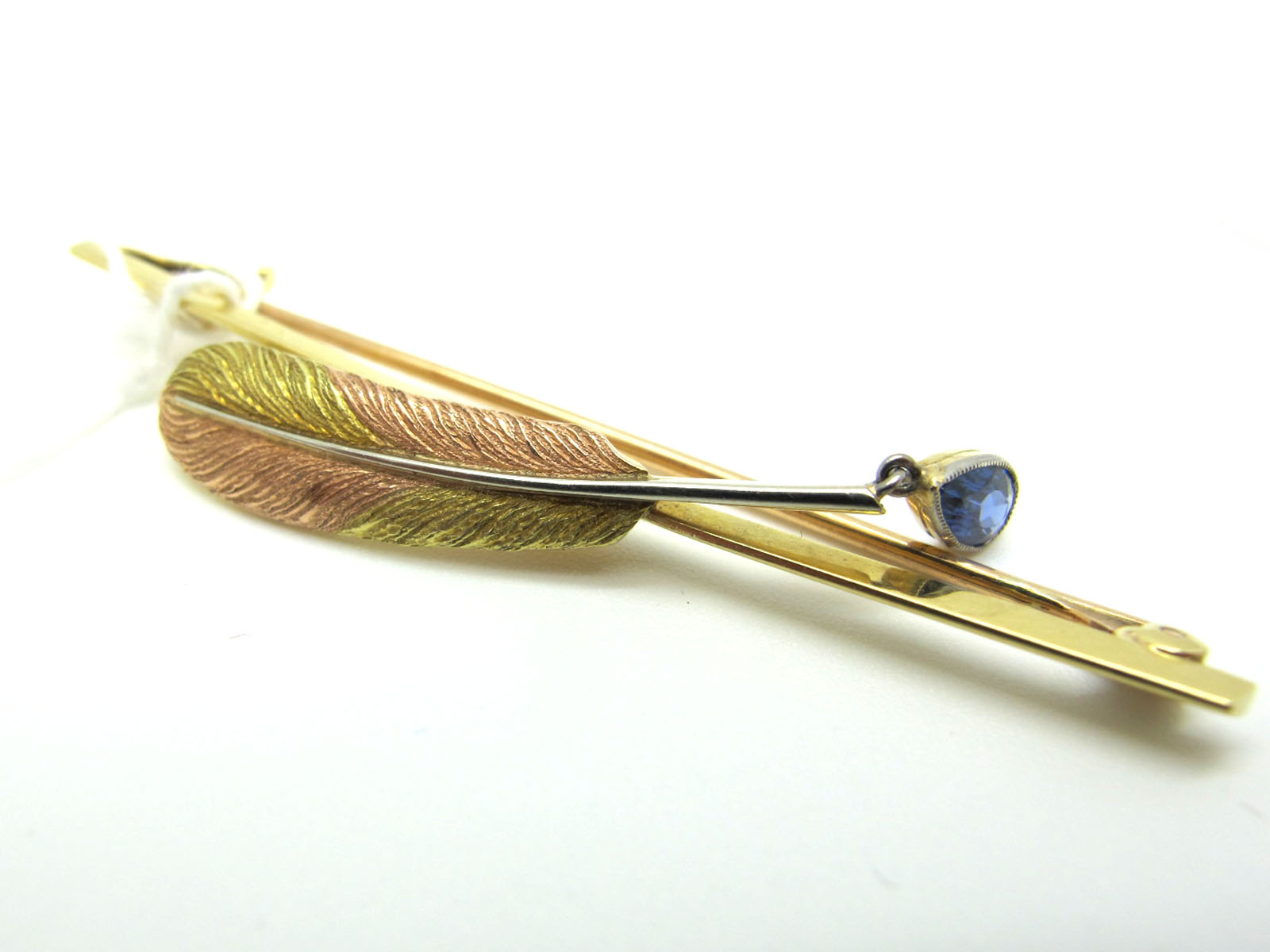 A Two Colour Quill Bar Brooch, of naturalistic design, on plain bar, suspending collet set teardrop,