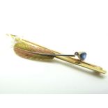 A Two Colour Quill Bar Brooch, of naturalistic design, on plain bar, suspending collet set teardrop,
