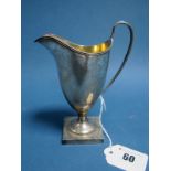 A Hallmarked Silver Helmet Shape Cream Jug, SB&S Ltd, Birmingham 1924, gilt lined, raised on