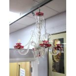 A Continental XX Century Glass Ceiling Light, with four fluted branches, with painted cranberry