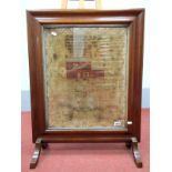 A XIX Century Needlework Sampler, mounted in a fire screen, worked with a red brick house, birds,