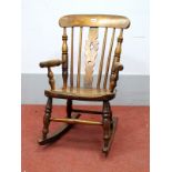 A XIX Century Child's Ash and Elm Rocking Chair, with pierced splat, rail supports, turned arms,