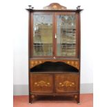 An Art Nouveau Mahogany Display Cabinet, with shaped gallery over leaded glazed doors, the