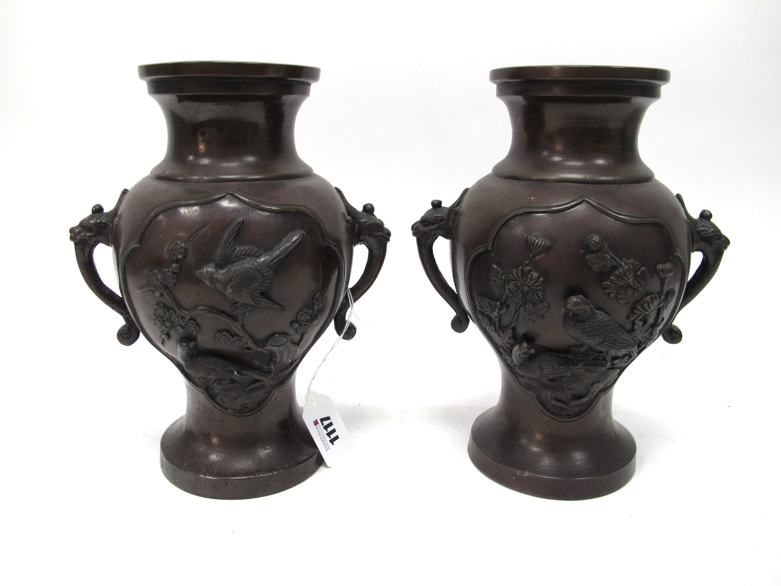 A Pair of Japanese Late XIX Century Bronze Vases, of two handled form, moulded in relief with