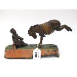 A Cold Painted Cast Iron Moneybox, modelled in the form of a bucking mule, beside a boy holding a