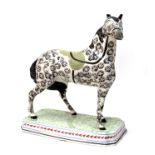 A Pearlware Pottery Model of a Stallion, probably Leeds Pottery c.1820-30, with black sponged